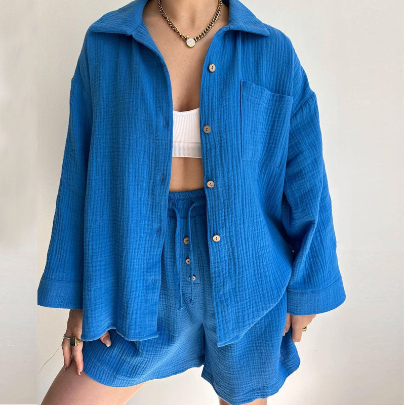 A woman wearing a flowing oversized shirt with drawstring shorts, relaxed and breezy.