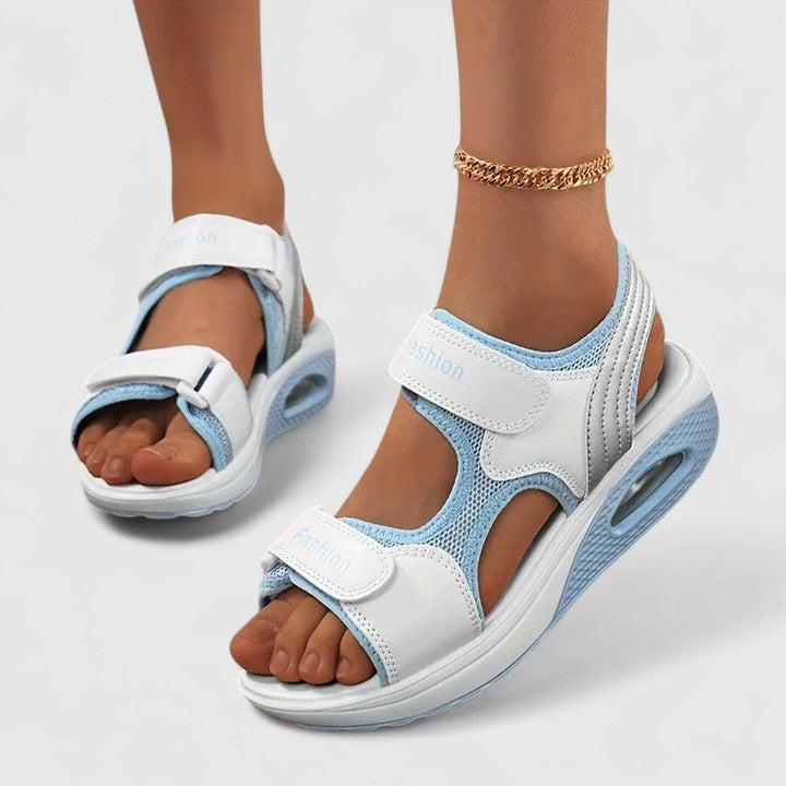 A woman in white sandals with a lilac trim walking comfortably, feet supported and light.