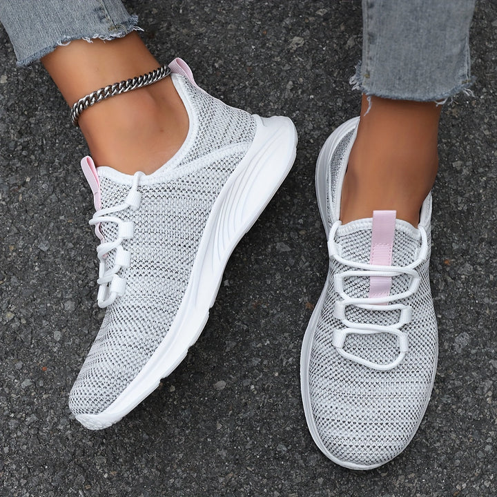 A woman walking comfortably in lightweight breathable trainers with trousers