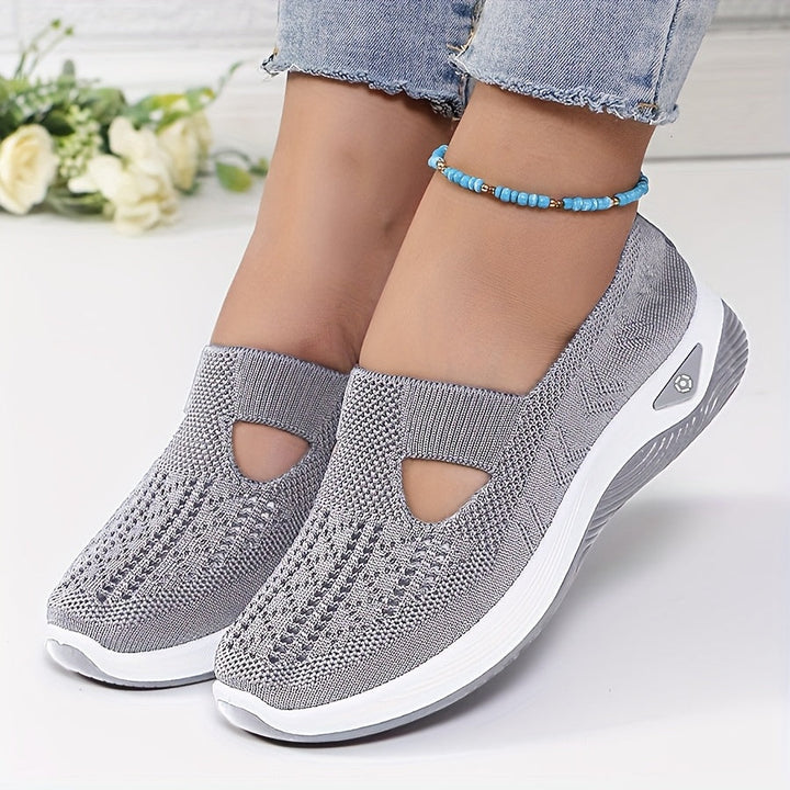 A woman stepping into easy slip-on comfort trainers with no laces.