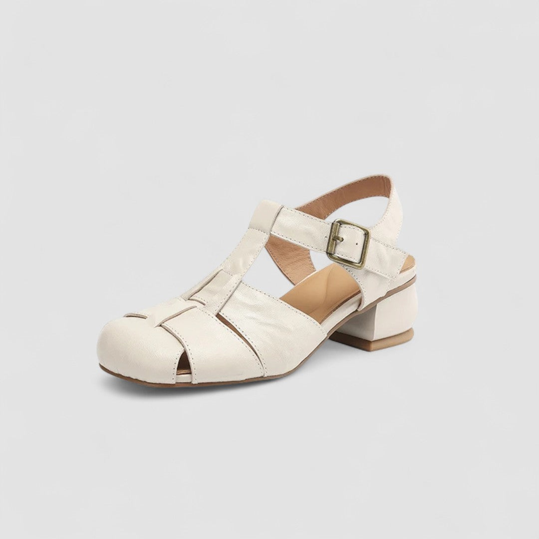 A woman in beige Mary Jane shoes with an ankle strap, comfortable browsing a market.