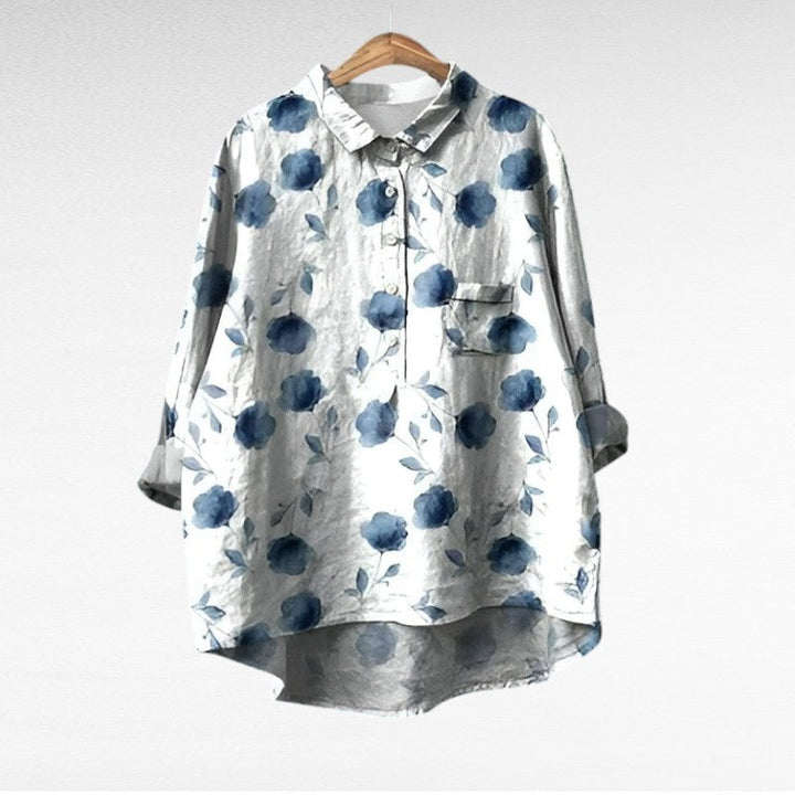 Woman wearing a printed summer blouse with a gentle, flattering drape.