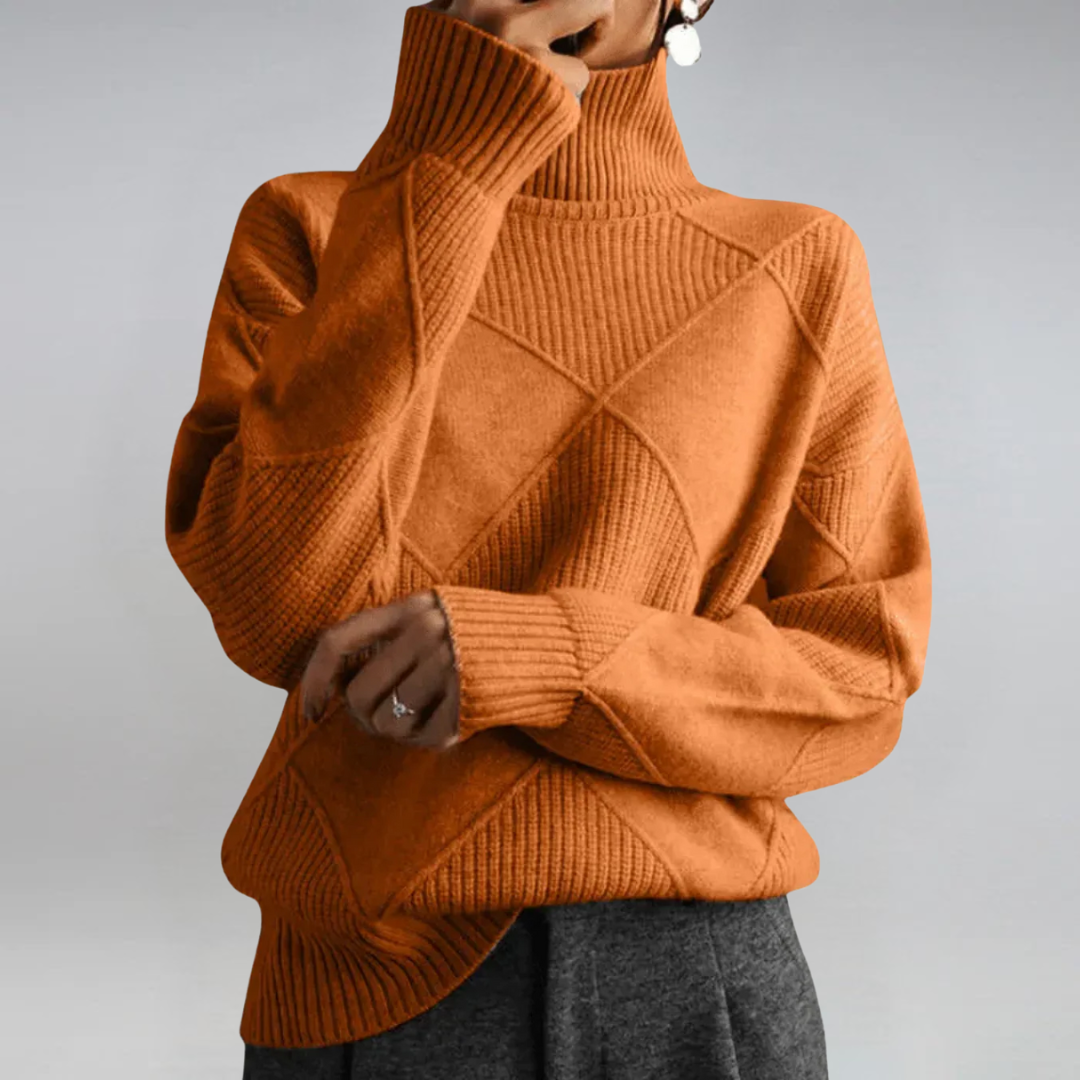 A woman in a stand-collar jumper with an elegant drape, styled with tailored trousers.
