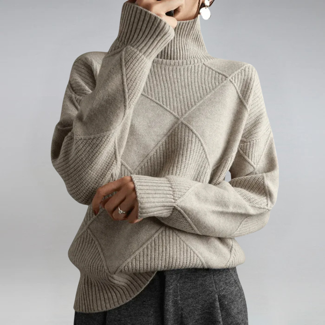 A woman in a stand-collar jumper with an elegant drape, styled with tailored trousers.