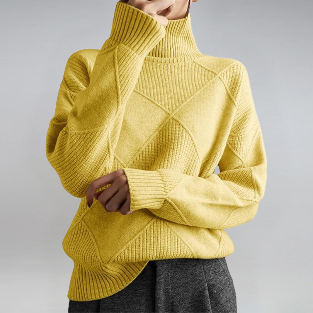 A woman in a stand-collar jumper with an elegant drape, styled with tailored trousers.