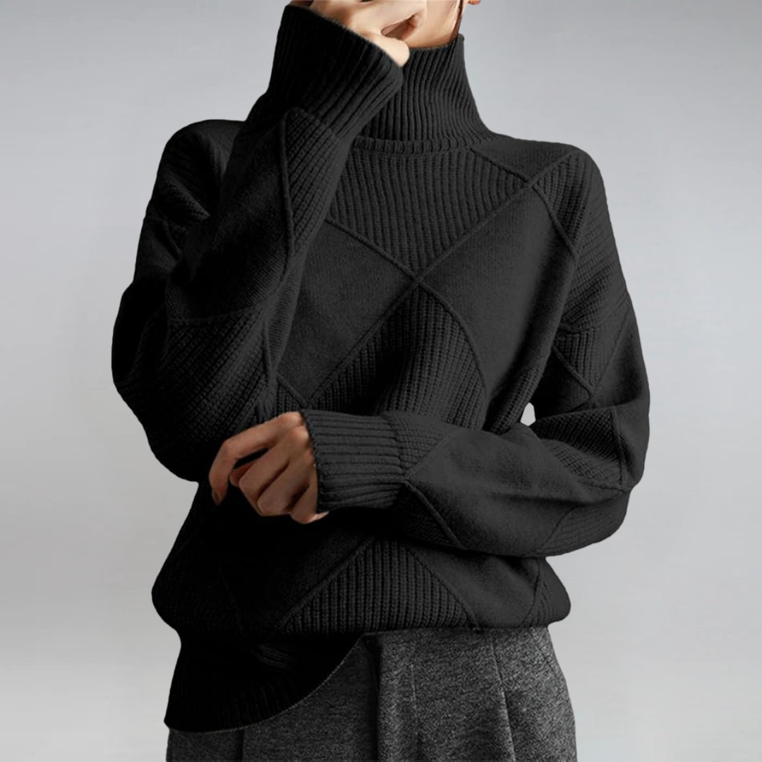 A woman in a stand-collar jumper with an elegant drape, styled with tailored trousers.