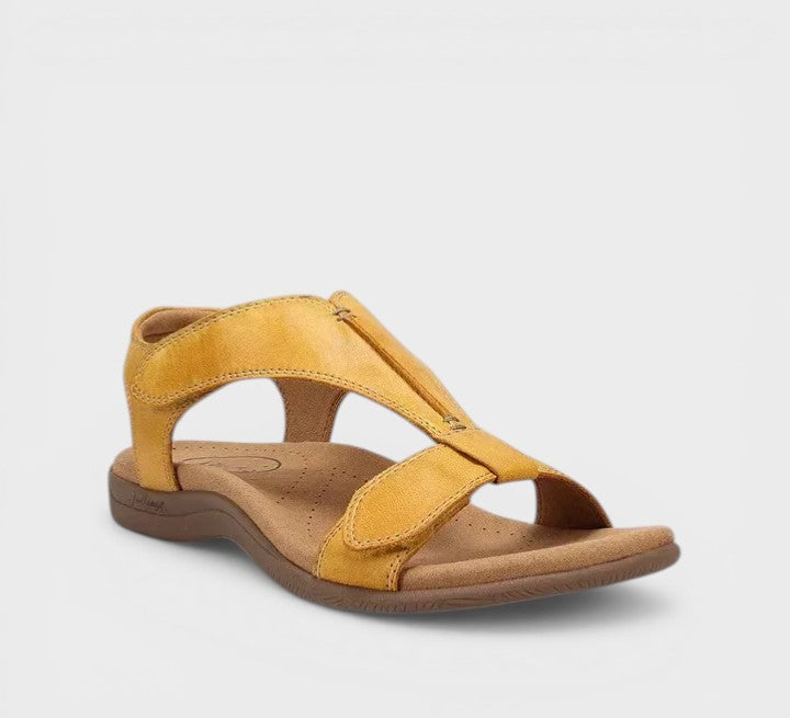 Elegant flat T-bar sandals in black and beige with a classic, refined strap design