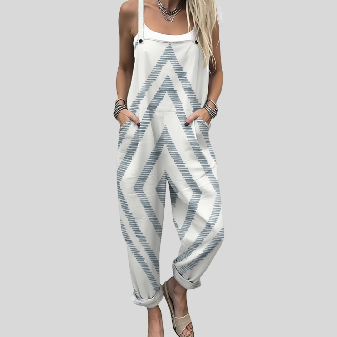 Women's relaxed wide-leg dungarees in white with soft blue-grey chevron zigzag lines across the fabric.