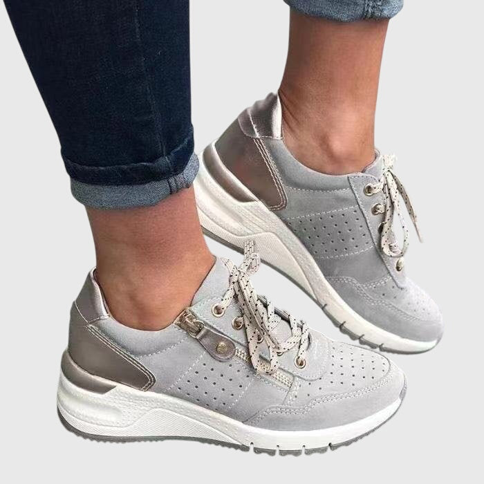 A woman on a walk wearing soft, supportive trainers on a bright day.
