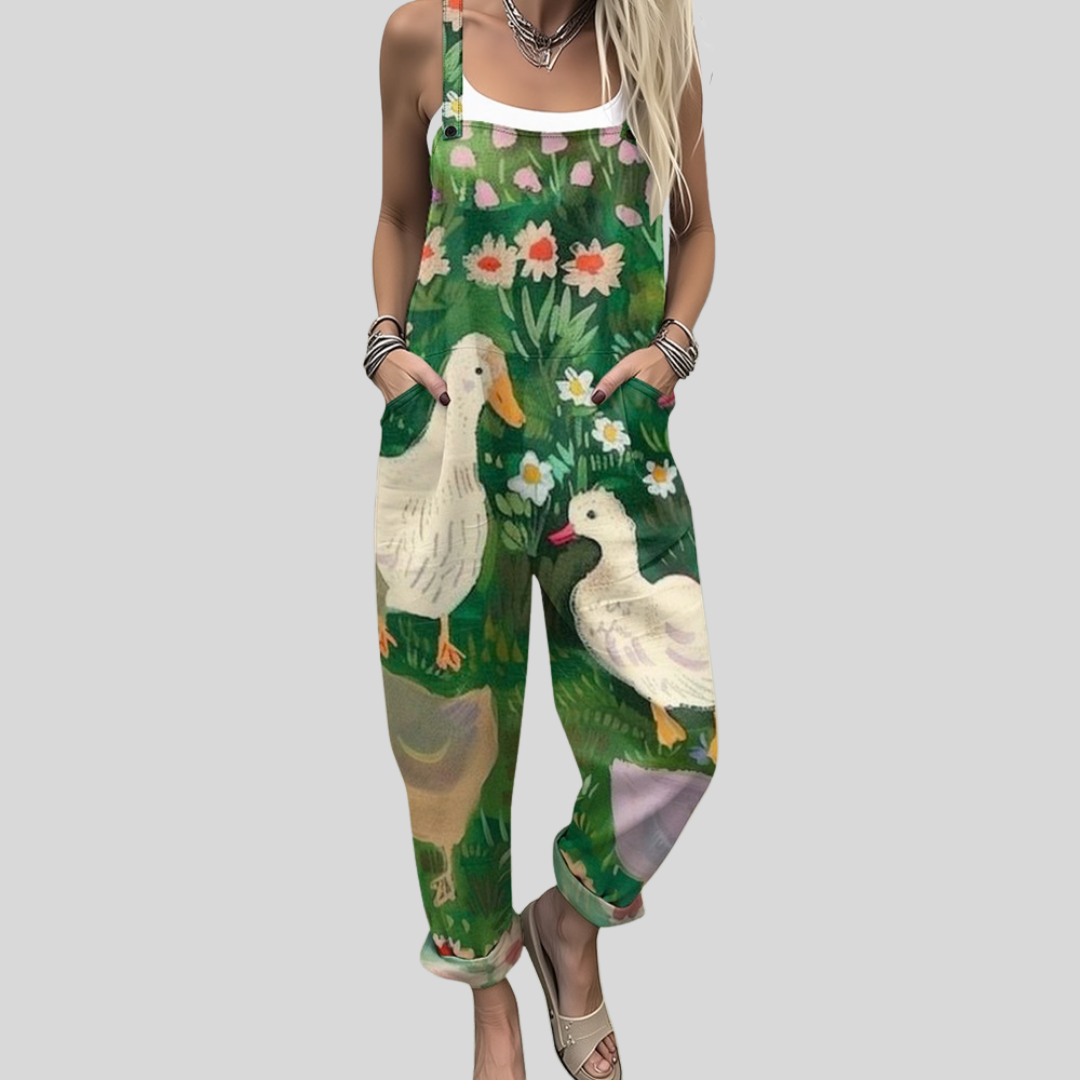 Deep green wide-leg dungarees with a naive-style print of white ducks among meadow grasses and flowers.