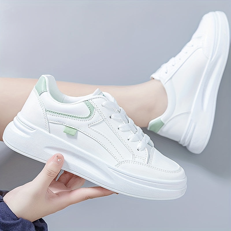 A woman in crisp white light comfort trainers paired with jeans.