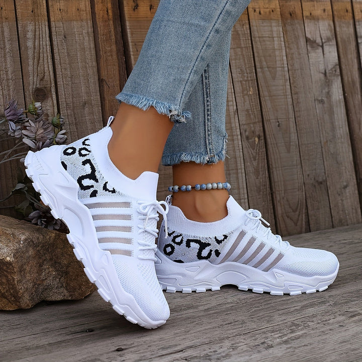 A woman walking in light, breathable comfort trainers on a warm day.