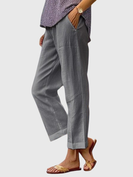 A woman wearing elegant tailored trousers with a flattering straight-leg cut and clean lines.