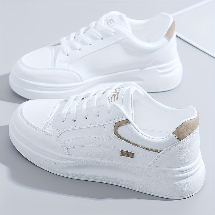 A woman in crisp white light comfort trainers paired with jeans.