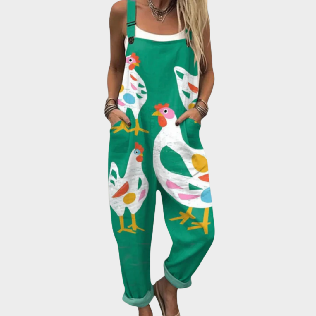 A woman in green dungarees with a playful hen print, relaxed fit and adjustable straps.