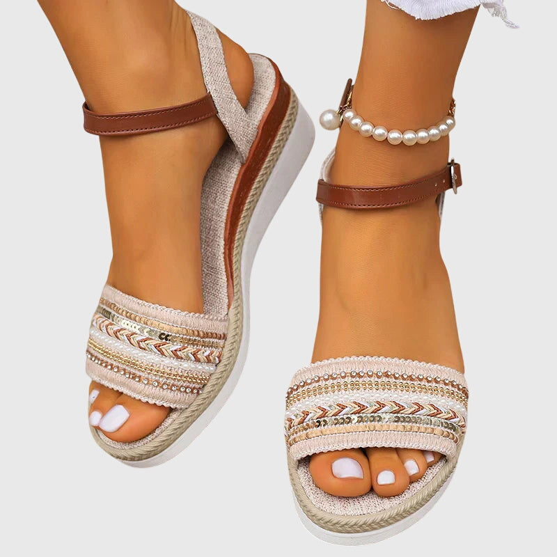 A woman walking easily in lightweight modern sandals in a soft white and brown finish.