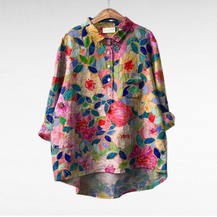 Woman wearing a flowing summer blouse with an elegant all-over print.