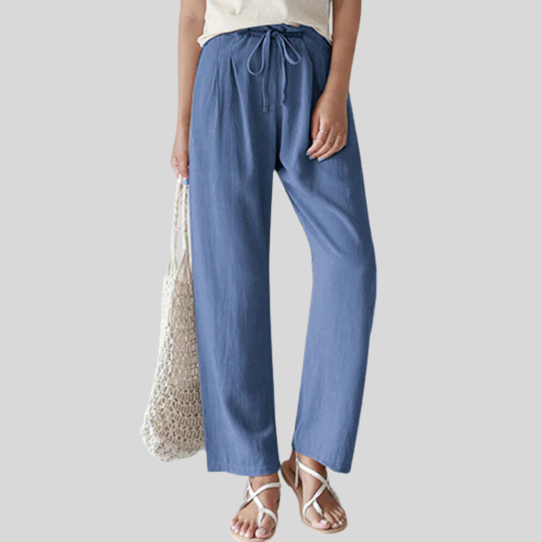 A woman walking outdoors in relaxed drawstring trousers with an easy, comfortable everyday look.