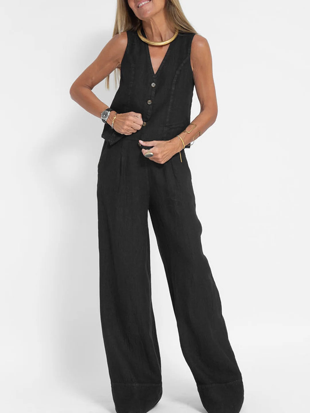 A woman wearing a tailored waistcoat with flowing wide-leg trousers