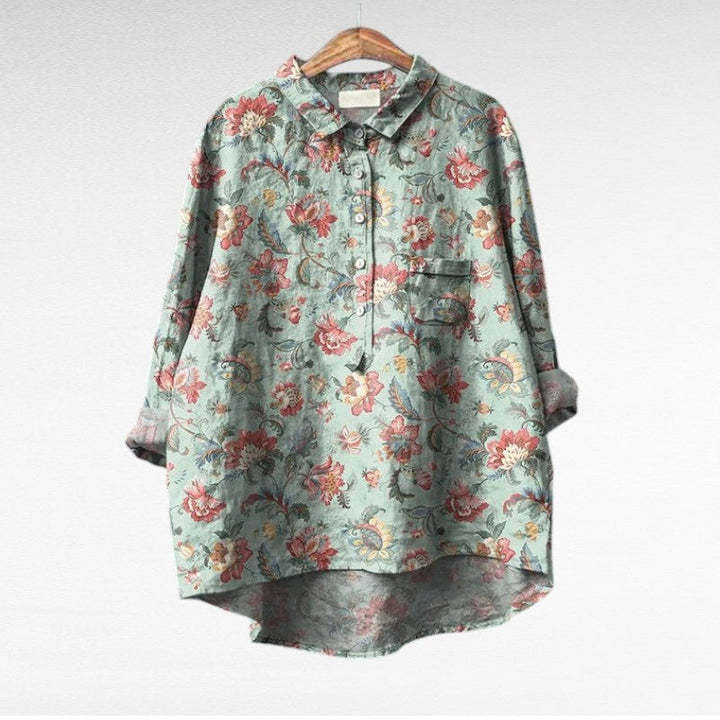 Woman wearing a flowing summer blouse with an elegant all-over print.