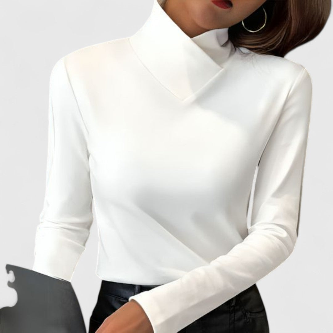 A woman wearing an elegant stand-collar jumper, slim and refined with a flattering line.