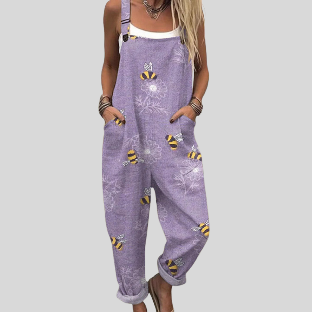 Women's relaxed dungarees in soft lilac with a whimsical print of golden bees and dandelion clocks.
