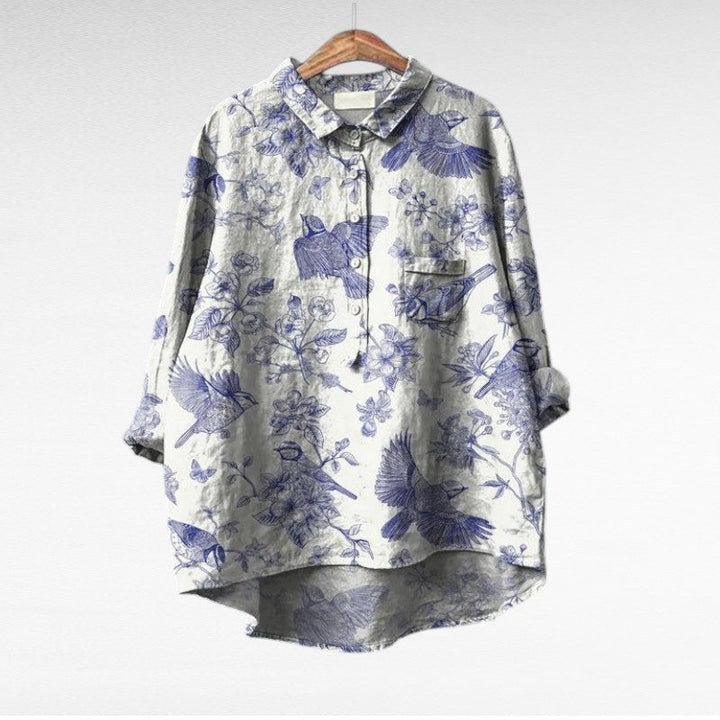 Woman wearing a flowing summer blouse with an elegant all-over print.