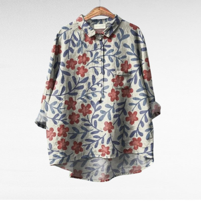 Woman wearing a flowing summer blouse with an elegant all-over print.