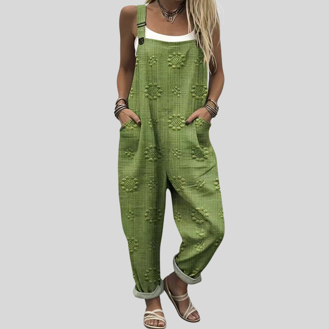 Women's relaxed tapered dungarees in vivid grass green with a subtle tone-on-tone raised daisy texture throughout the fabric.