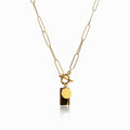 Gold chain necklace with a sleek rectangular clasp on a plain background