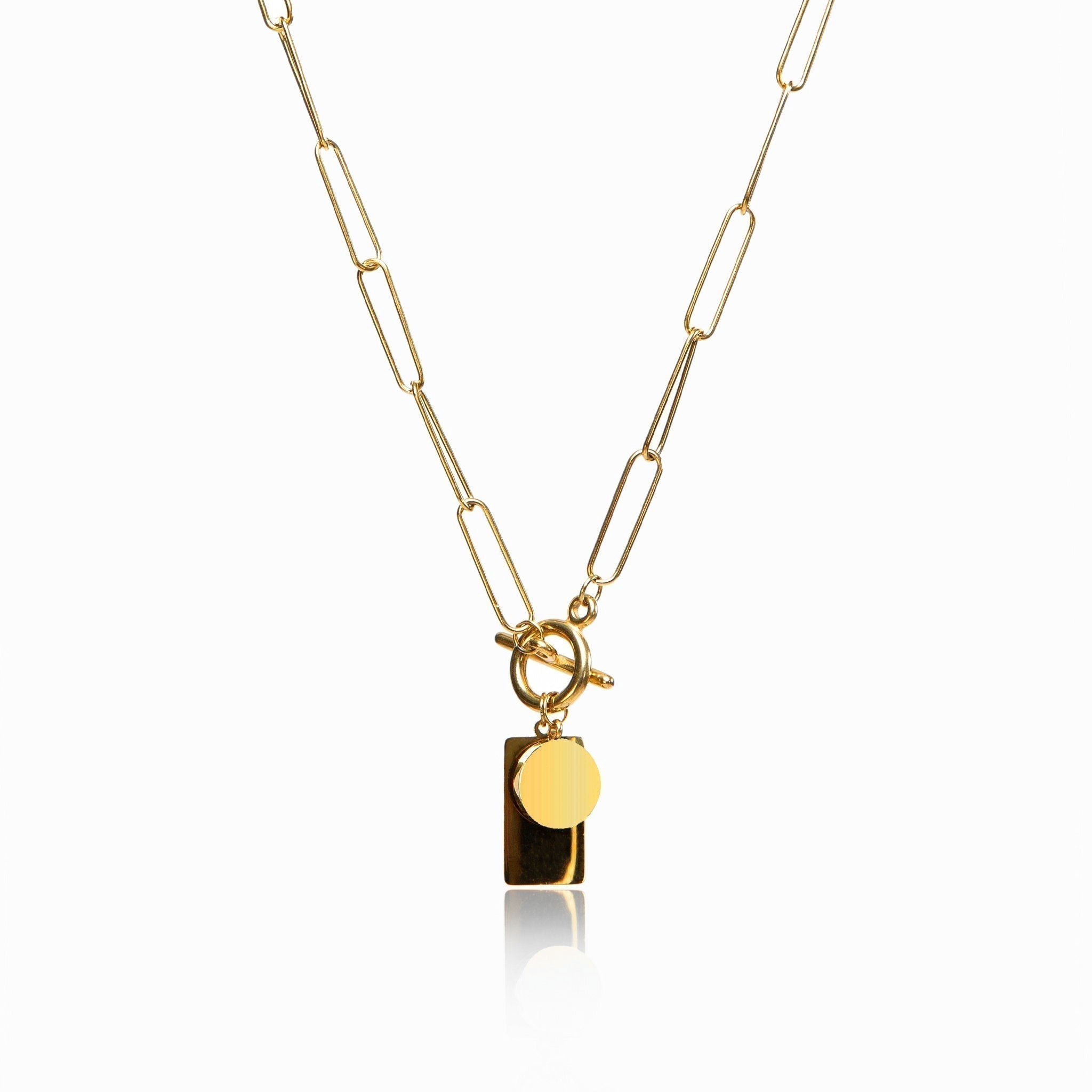 Gold chain necklace with a sleek rectangular clasp on a plain background