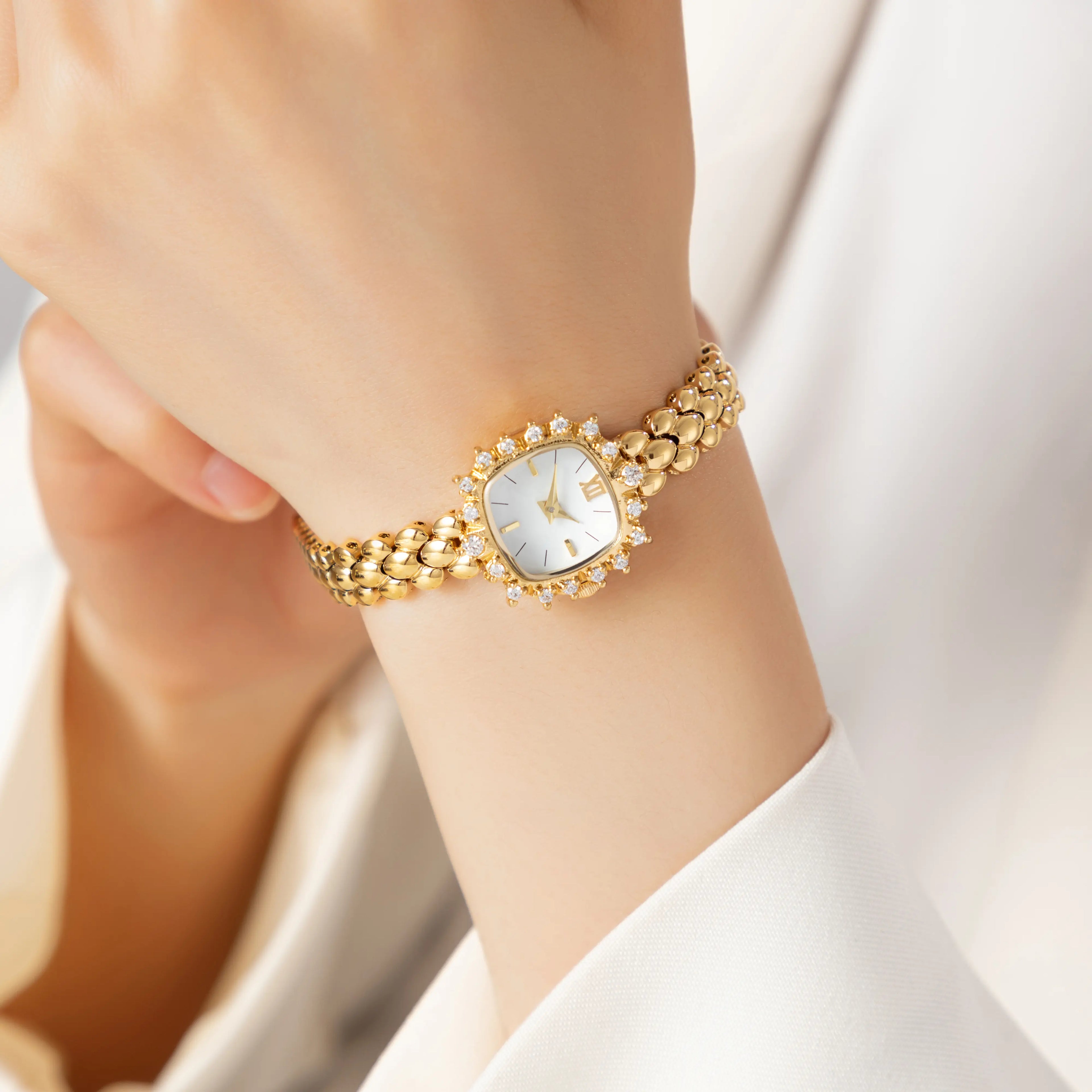 Slim women's bracelet watch with a vibrant colour detail against a simple light dial