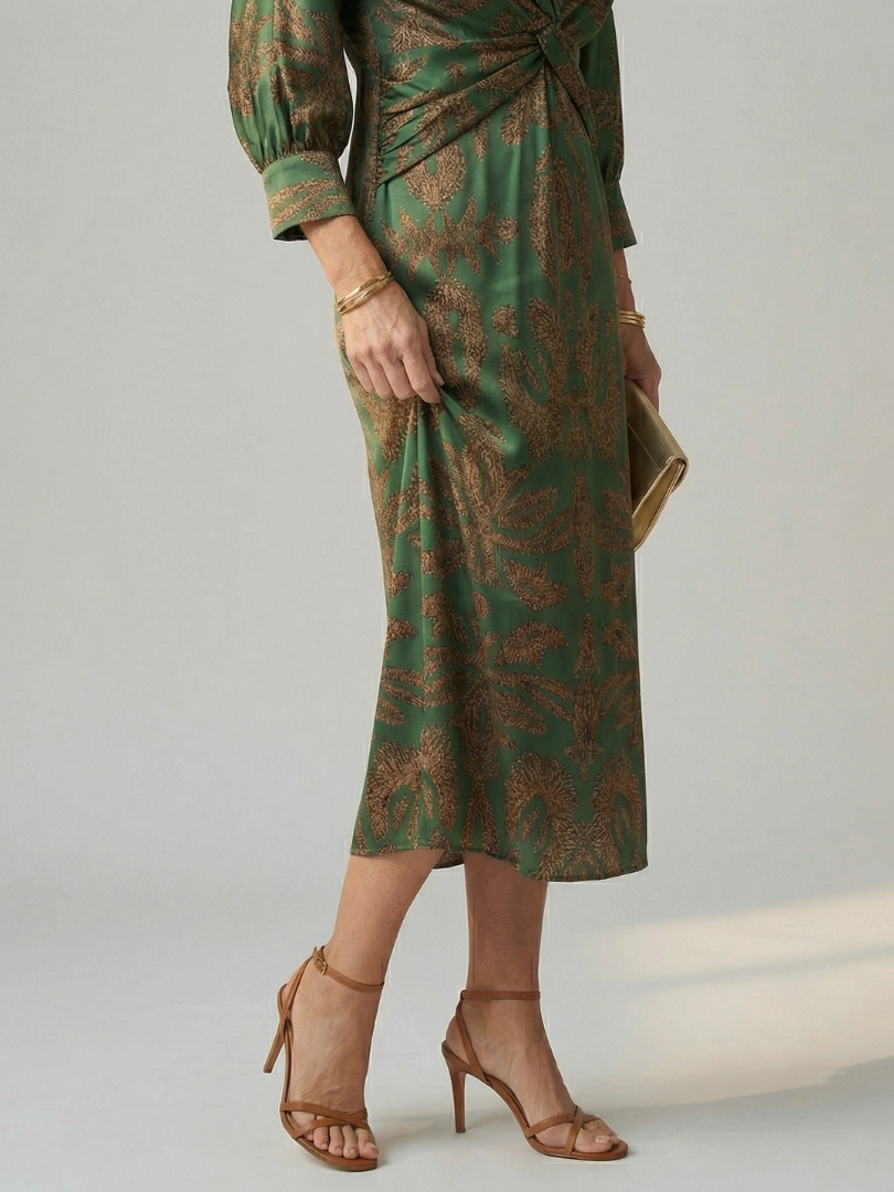 Dark green long-sleeve midi dress with diagonal wrap bodice and straight skirt in a detailed print