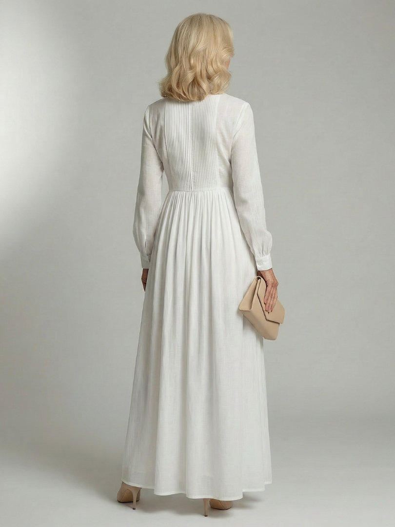 White long-sleeve button-front maxi dress with a gathered waist and full flowing skirt