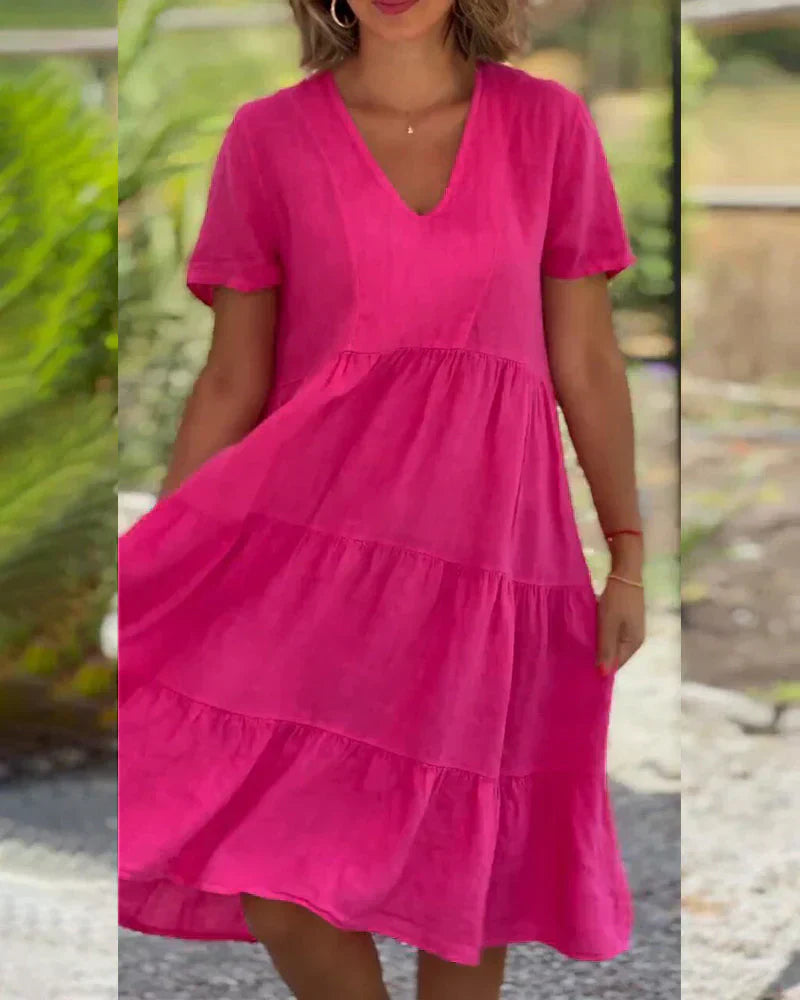 Woman wearing the Veronica™ V-neck summer dress with a soft layered skirt, strolling on a sunny afternoon.