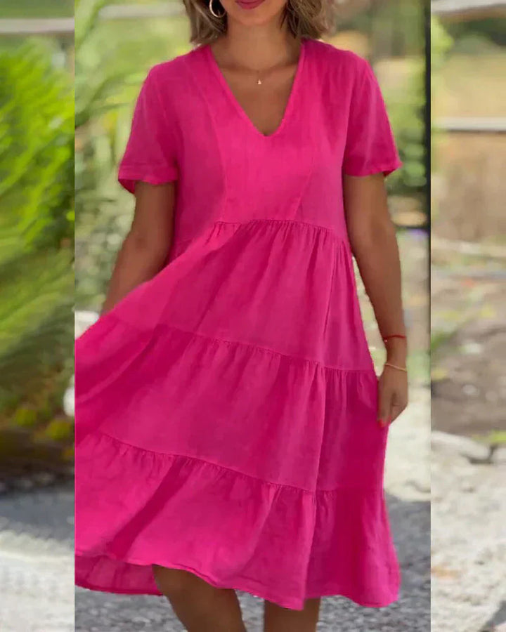 Woman wearing the Veronica™ V-neck summer dress with a soft layered skirt, strolling on a sunny afternoon.