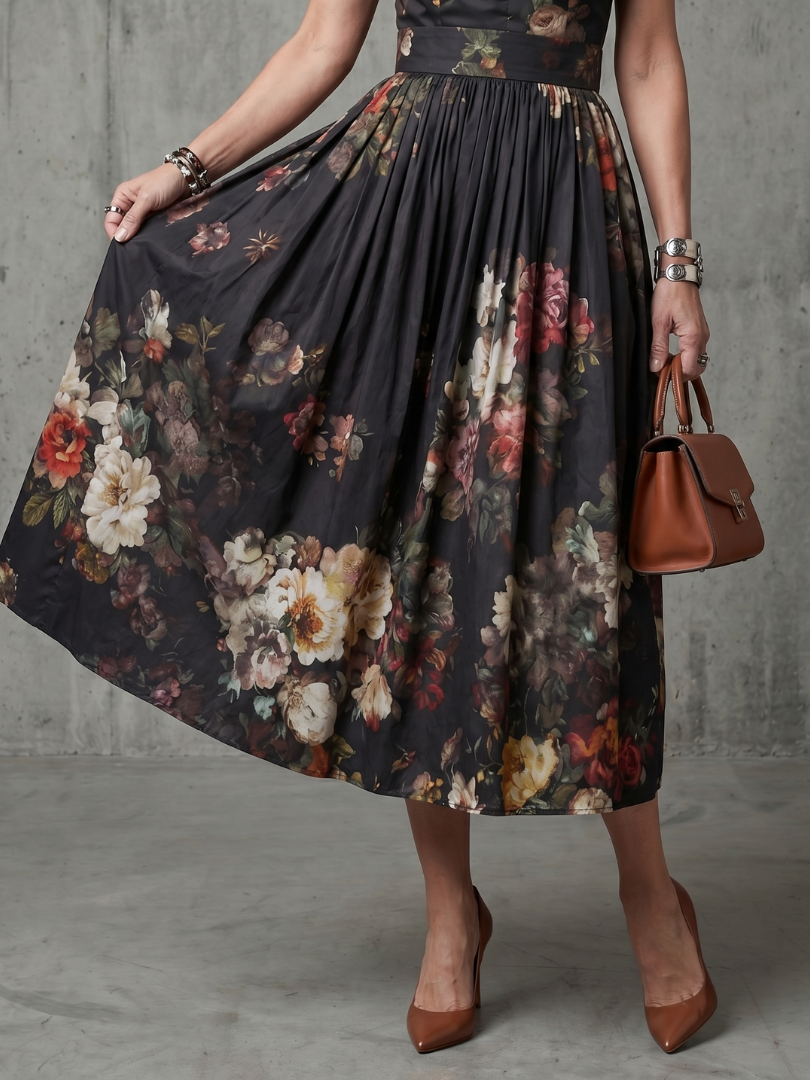 Black floral sleeveless midi dress with high neck and gently pleated skirt