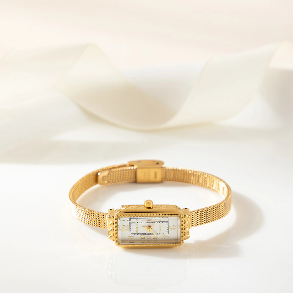 Women's classic watch with a textured strap and rounded dial in warm gold tone