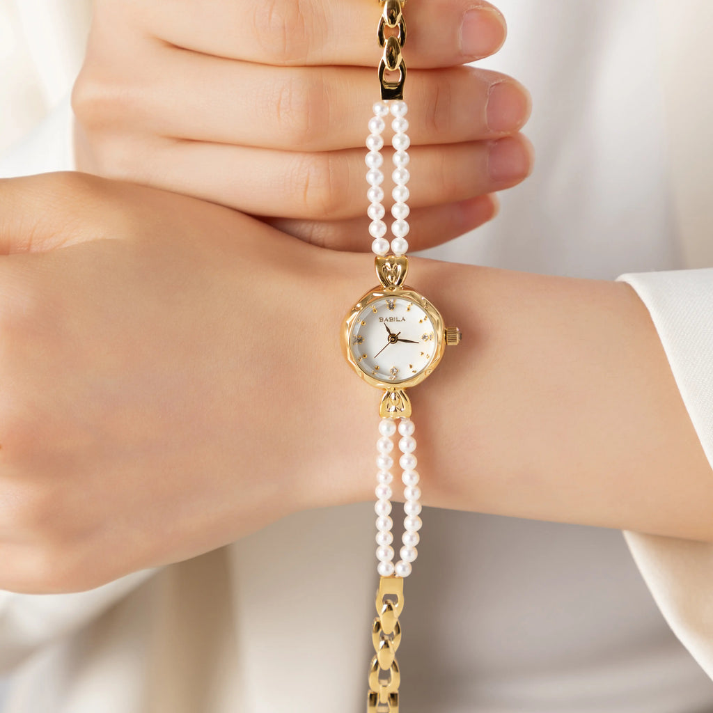 Women's gold watch with elegant twisted chain bracelet strap and a refined dial
