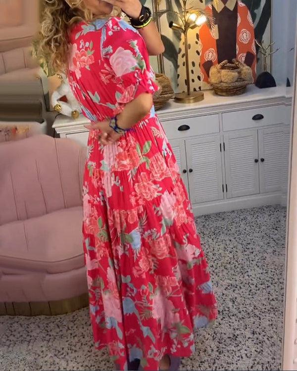 A woman wearing the Josephine bold floral maxi dress with a flowing full-length skirt at a garden gathering.