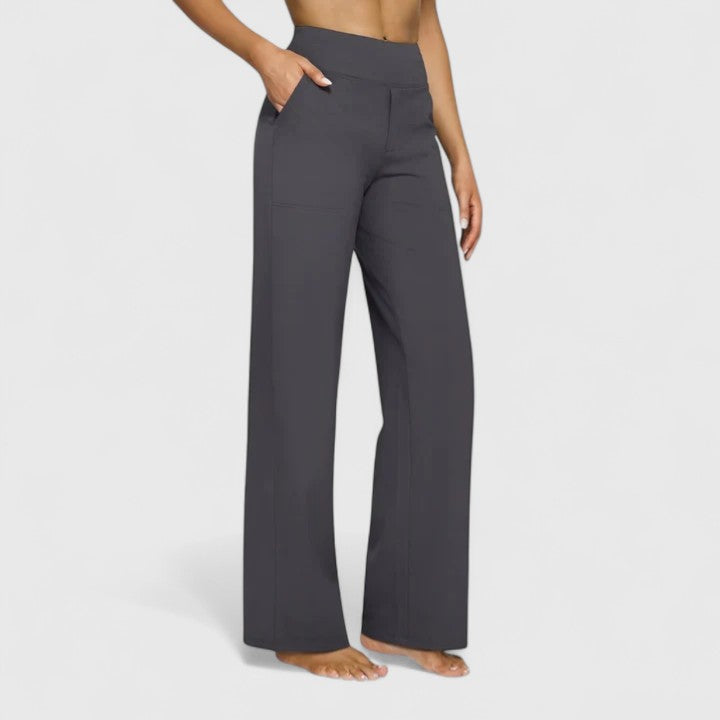 Woman wearing pull-on trousers with a soft blouse, relaxed and comfortable at home.