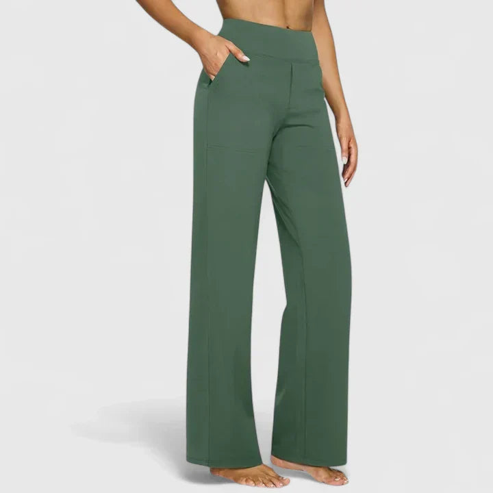 A woman in tailored trousers styled with a simple top for an elegant, comfortable everyday look.