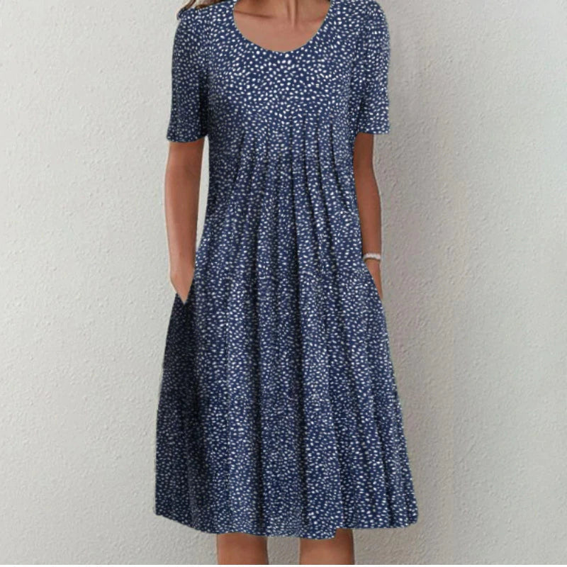 Woman wearing the floral midi dress with pockets, walking outdoors on a sunny day.