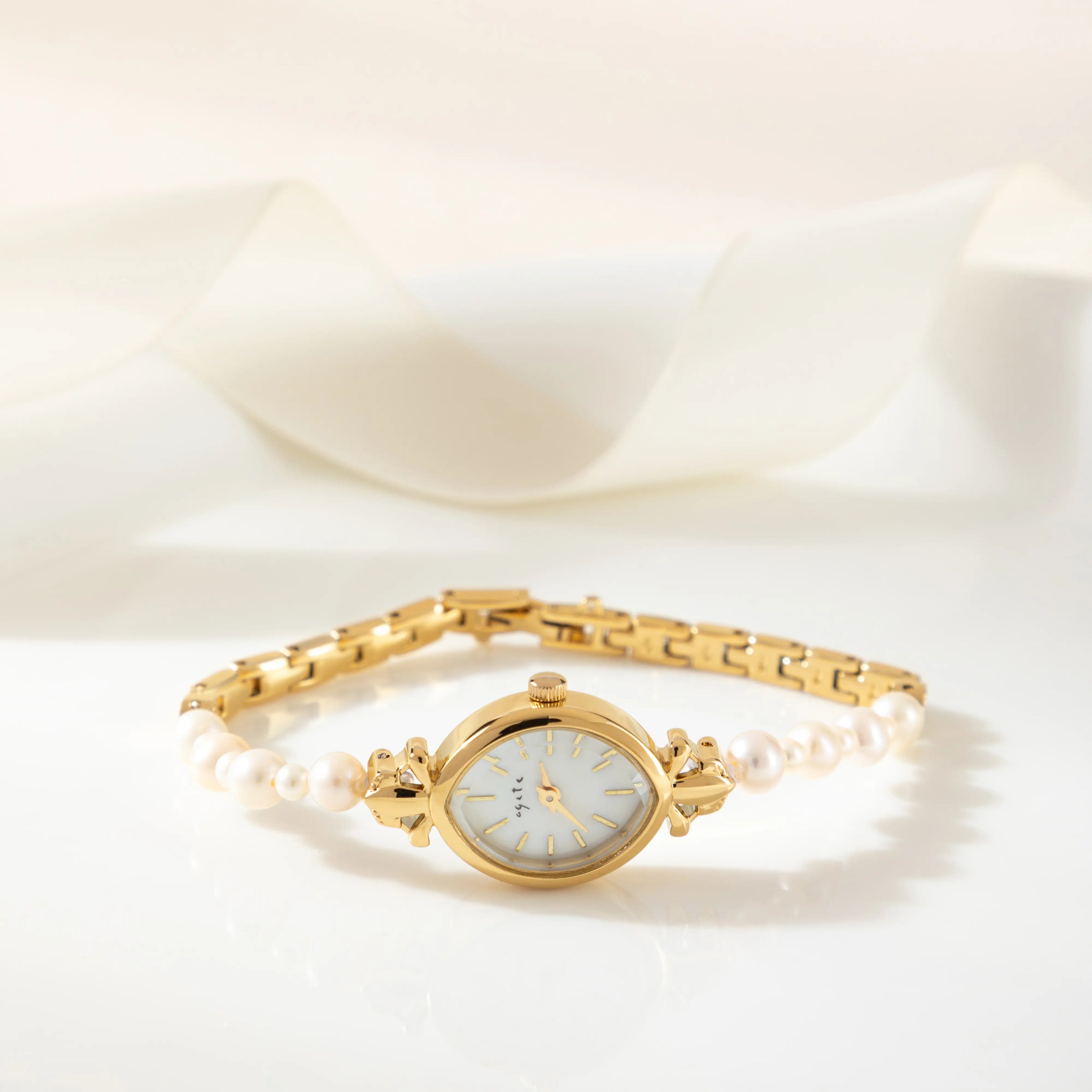 Elegant women's watch with crystal-set dial and delicate golden bracelet strap