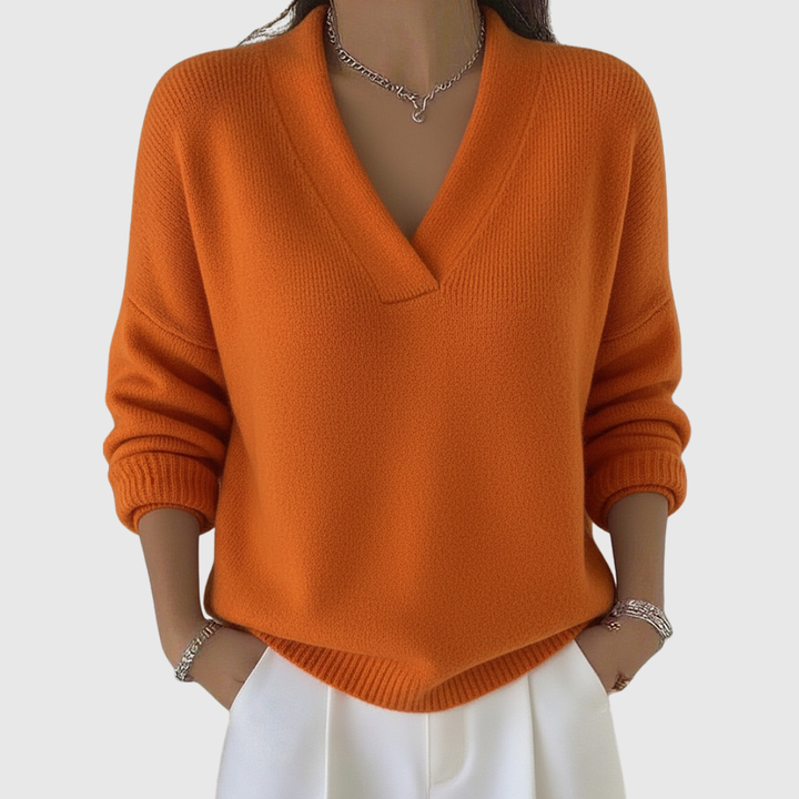 A woman wearing a soft draped V-neck jumper with jeans for an effortlessly elegant look.