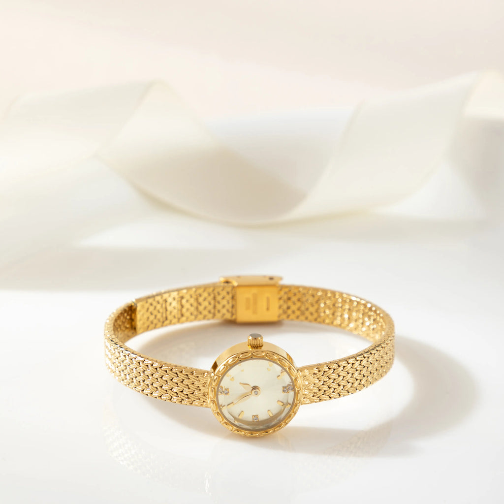 Women's minimalist gold watch with a simple round face and clean gold-tone finish