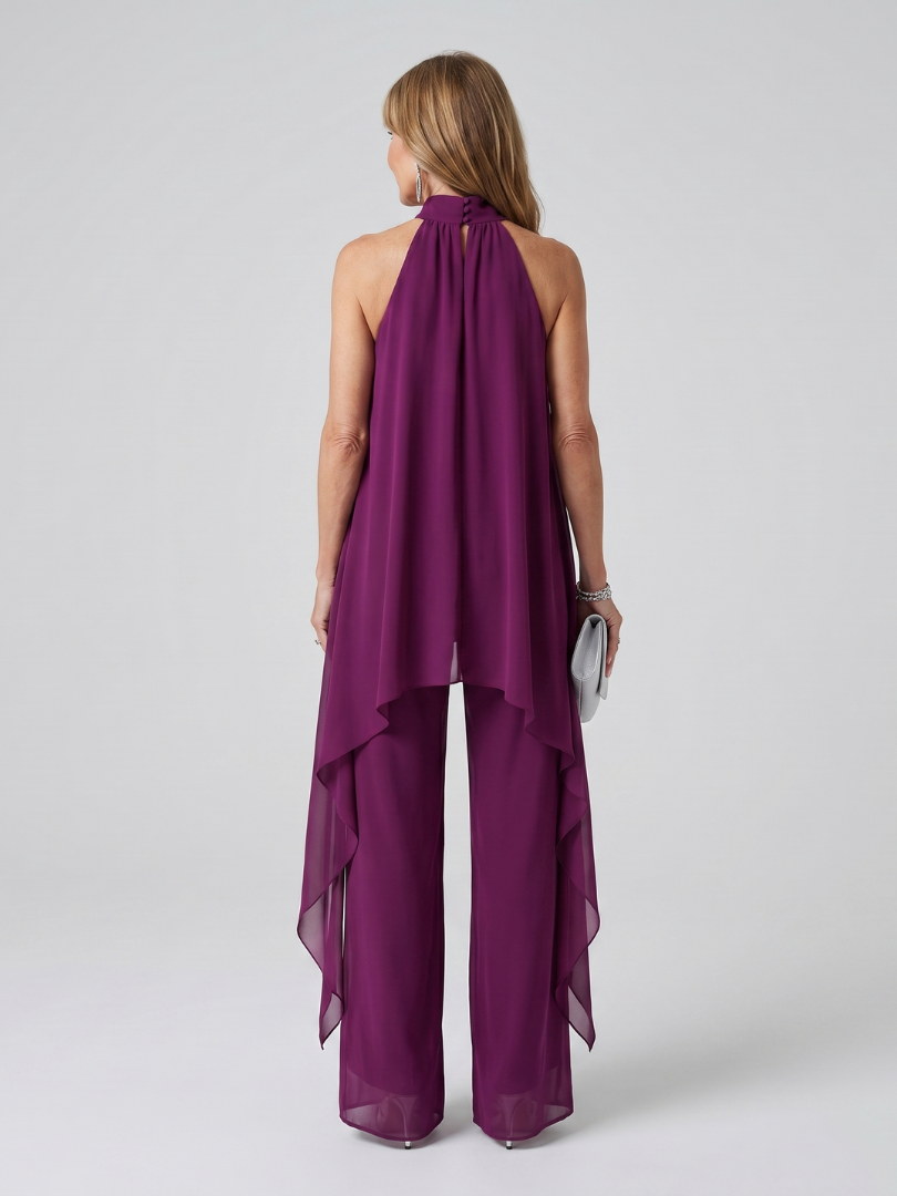Purple halter neck tunic top with matching wide-leg trousers and a sheer asymmetric overlay