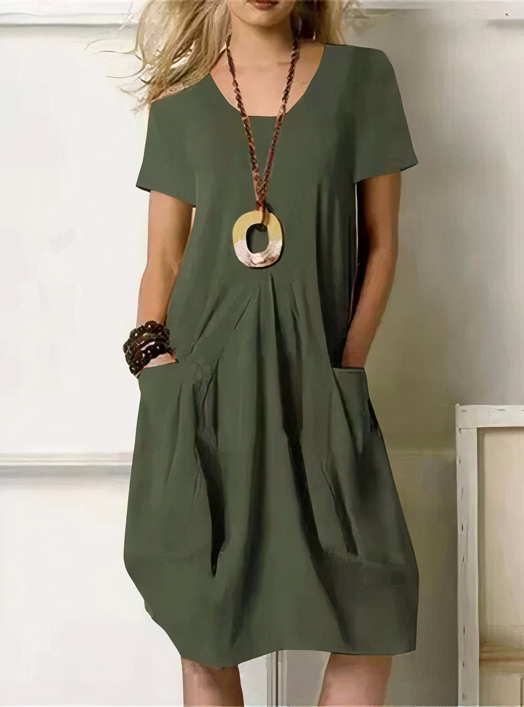 Woman wearing the Pauline™ A-line midi dress with pockets and a round neckline, out on an everyday errand.