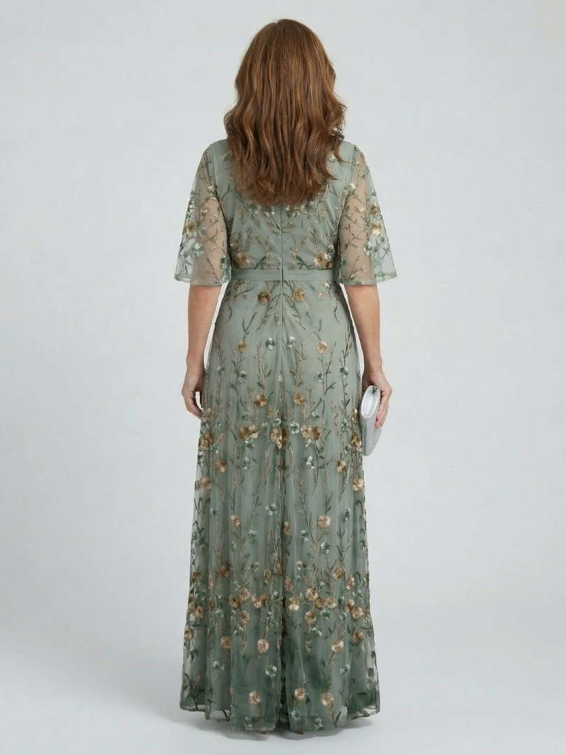 Sage green halter-neck midi dress with all-over floral print and loose flowing silhouette