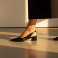 Black orthopaedic comfort heels with a wide toe box and low supportive heel